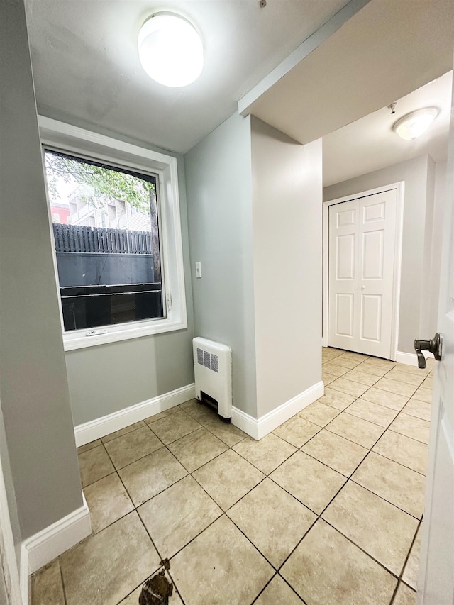 552 38th St Unit B4, Union City, NJ 07086 - spare room with radiator heating unit and light tile patterned floors