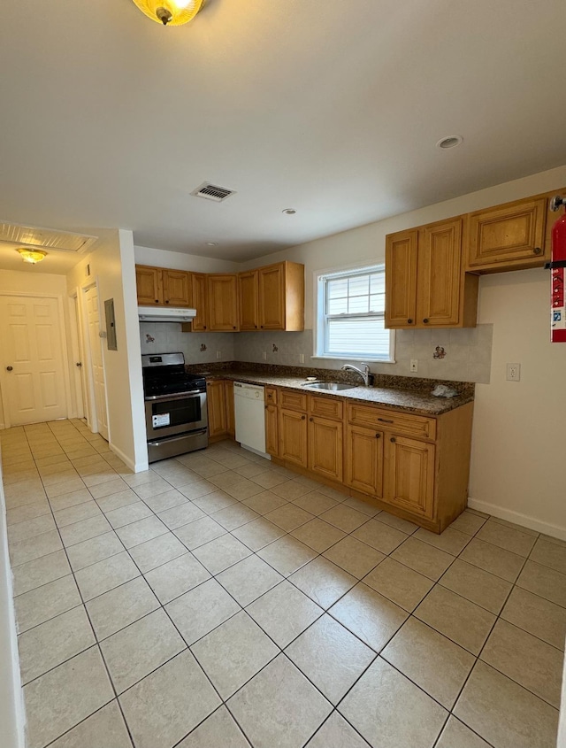 1502 44th St, North Bergen, NJ 07047 - kitchen featuring stainless steel range with gas stovetop, dishwasher, under cabinet range hood, light tile patterned floors, and dark countertops