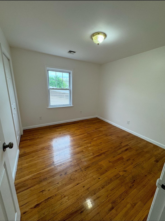 1502 44th St, North Bergen, NJ 07047 - empty room with wood finished floors and baseboards