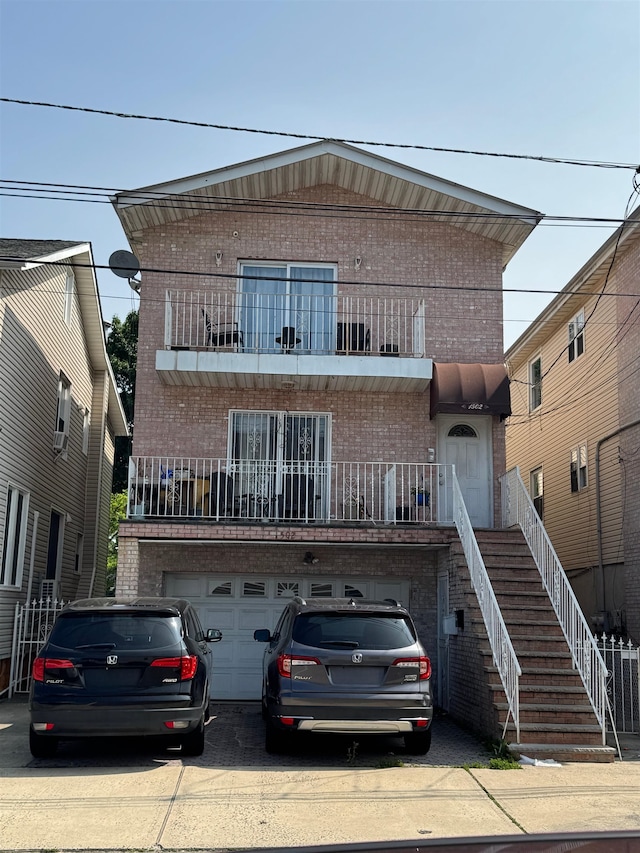 1502 44th St, North Bergen, NJ 07047 - view of front of home with brick siding, driveway, a balcony, and an attached garage