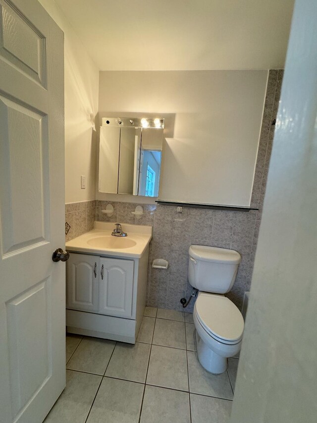1502 44th St, North Bergen, NJ 07047 - bathroom featuring tile walls, tile patterned floors, toilet, and vanity