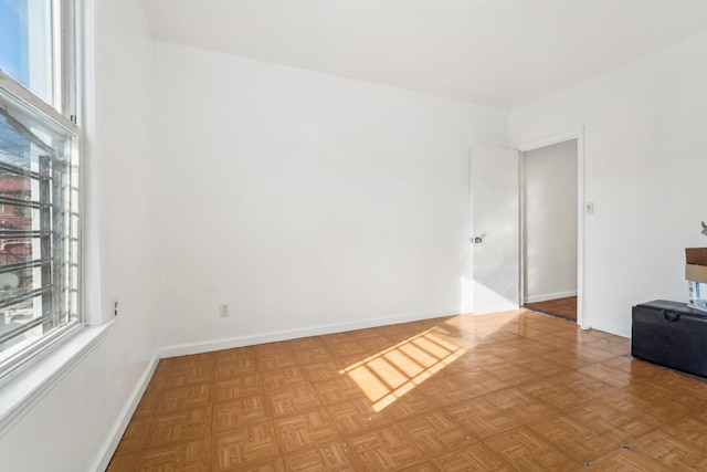 unfurnished room featuring parquet floors