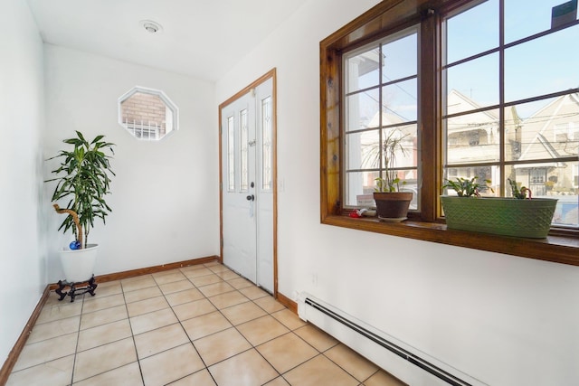 tiled entrance foyer with a baseboard heating unit