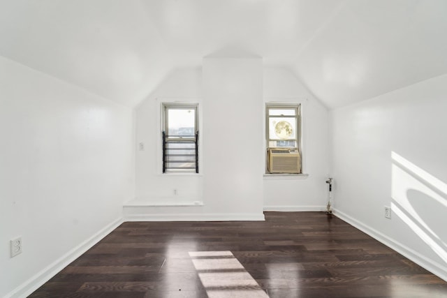 bonus room featuring a wealth of natural light, cooling unit, dark wood-type flooring, and vaulted ceiling