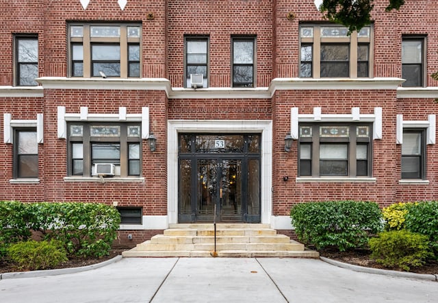 property entrance featuring french doors and brick siding