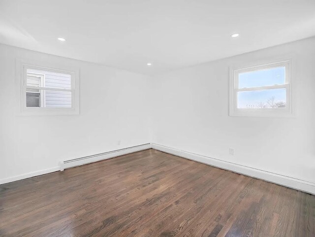 21 Freedom Pl, Jersey City, NJ 07065 - empty room with wood finished floors, baseboards, recessed lighting, and a baseboard heating unit