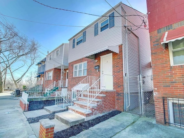 21 Freedom Pl, Jersey City, NJ 07065 - view of front of house with brick siding and a gate