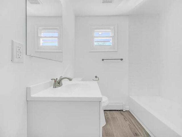 21 Freedom Pl, Jersey City, NJ 07065 - full bathroom featuring vanity, toilet, plenty of natural light, and baseboard heating