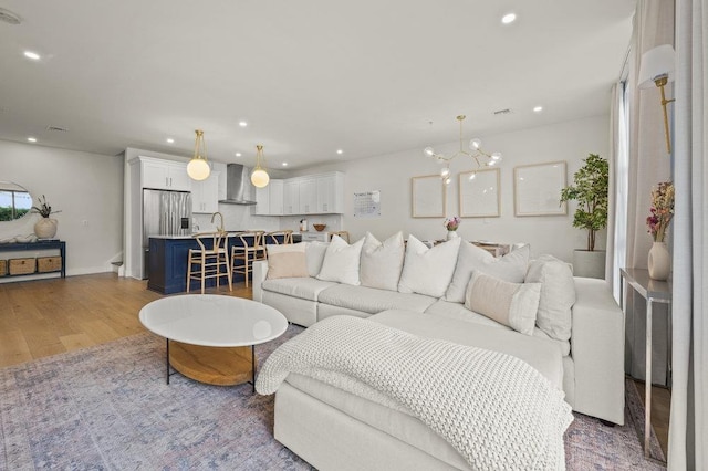 living room featuring a chandelier and hardwood / wood-style flooring