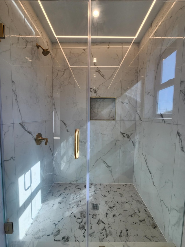 bathroom with a shower with door