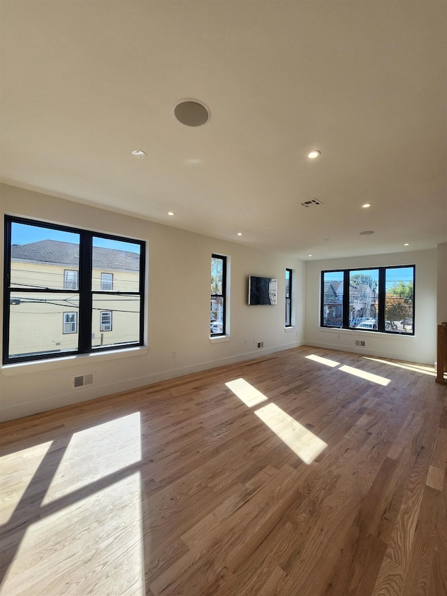 unfurnished living room featuring light hardwood / wood-style floors