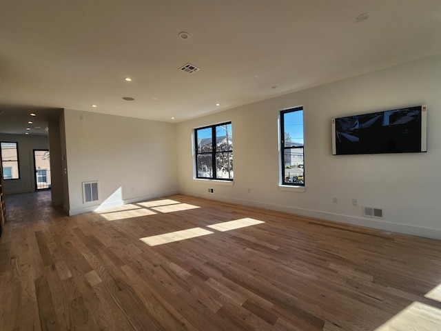 unfurnished room with dark hardwood / wood-style flooring