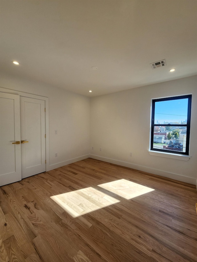 spare room featuring light hardwood / wood-style flooring