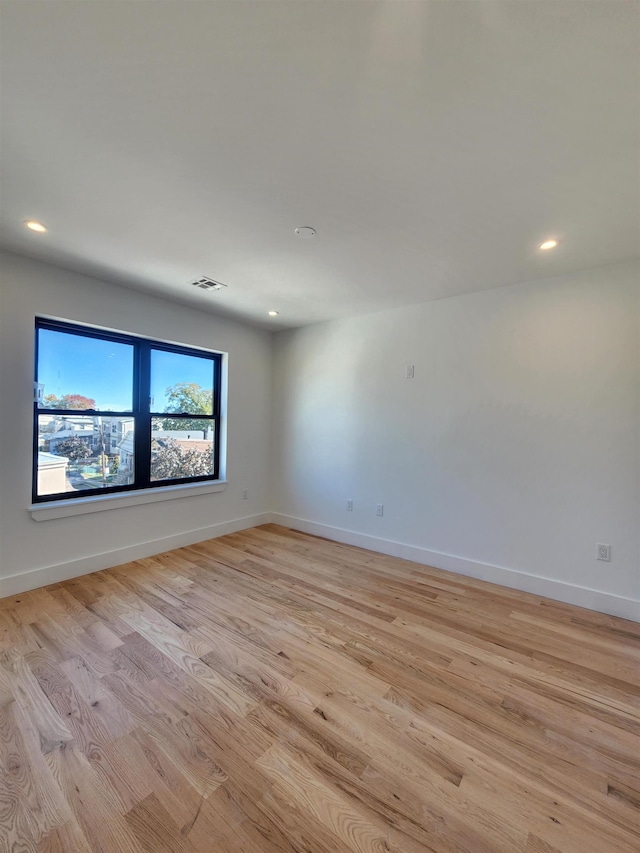 unfurnished room with light hardwood / wood-style flooring