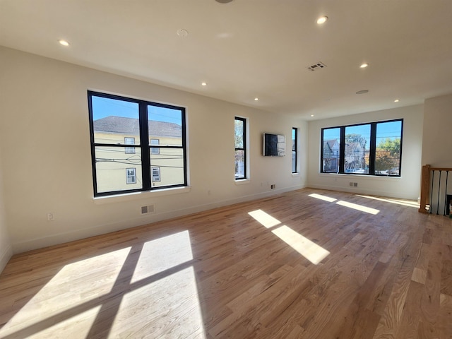 empty room with light hardwood / wood-style flooring