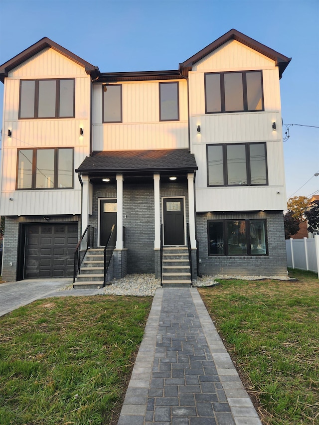 view of front of property with a front lawn and a garage