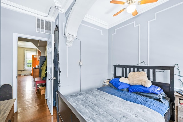 233 Summit Ave, Jersey City, NJ 07304 - bedroom featuring crown molding, wood finished floors, arched walkways, and ceiling fan