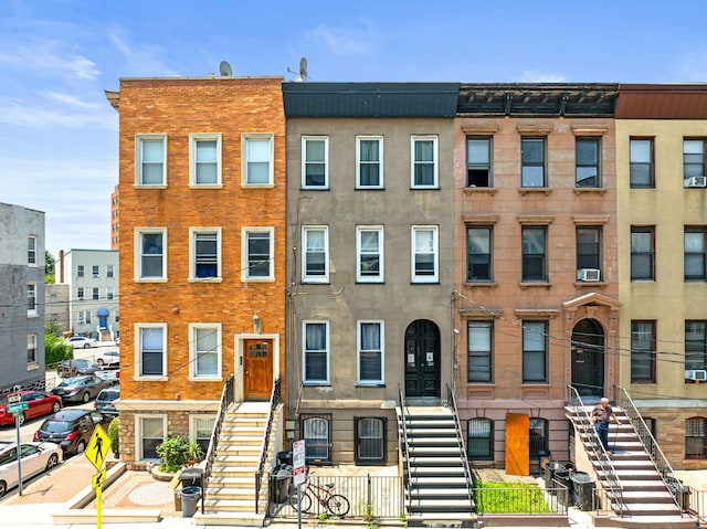 233 Summit Ave, Jersey City, NJ 07304 - view of front of house featuring stairs, a fenced front yard, and cooling unit
