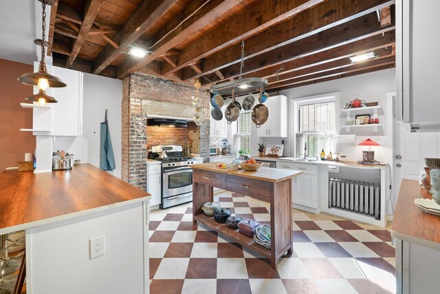 233 Summit Ave, Jersey City, NJ 07304 - kitchen featuring stainless steel range with gas cooktop, butcher block counters, open shelves, and a wood ceiling with exposed beams