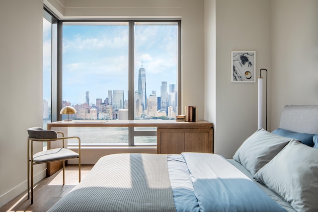 99 Hudson St Unit 3708, Jersey City, NJ 07302 - bedroom with wood finished floors, baseboards, and a city view