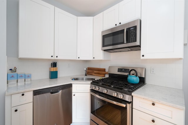34 Romaine Ave Unit 2, Jersey City, NJ 07306 - kitchen featuring appliances with stainless steel finishes, decorative backsplash, and white cabinetry