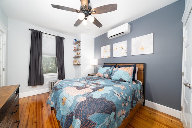 34 Romaine Ave Unit 2, Jersey City, NJ 07306 - bedroom with a wall unit AC, radiator heating unit, hardwood / wood-style floors, and ceiling fan