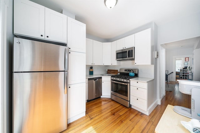 34 Romaine Ave Unit 2, Jersey City, NJ 07306 - kitchen featuring stainless steel appliances, light wood-type flooring, light countertops, and white cabinets