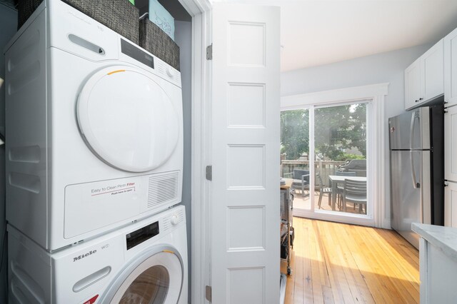 34 Romaine Ave Unit 2, Jersey City, NJ 07306 - laundry room featuring stacked washer / dryer and light wood-style flooring