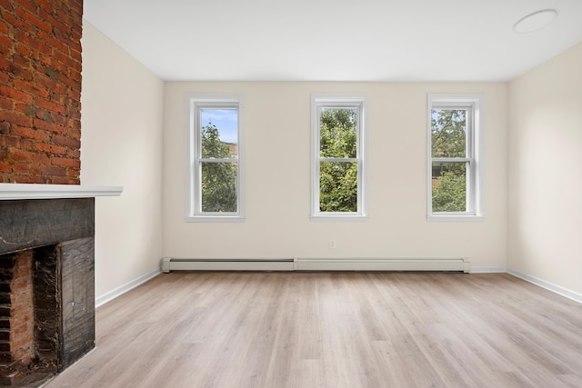 366 7th St Unit 2, Jersey City, NJ 07302 - unfurnished living room with wood finished floors, plenty of natural light, and a brick fireplace