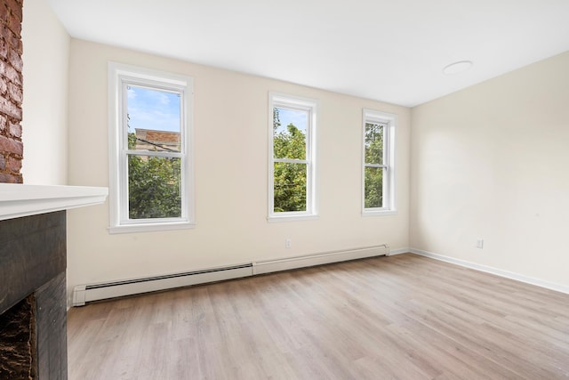 366 7th St Unit 2, Jersey City, NJ 07302 - unfurnished living room with a baseboard heating unit, wood finished floors, and a fireplace