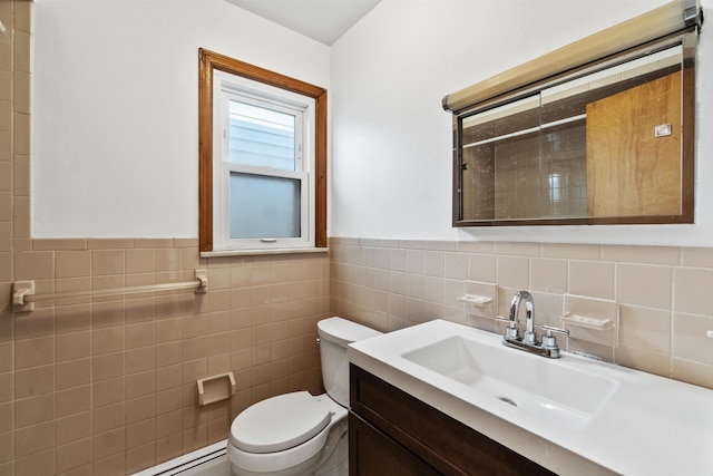 bathroom featuring vanity, a baseboard radiator, wainscoting, tile walls, and toilet