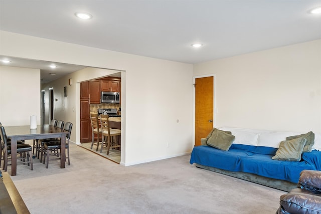 living room with light carpet, recessed lighting, and baseboards