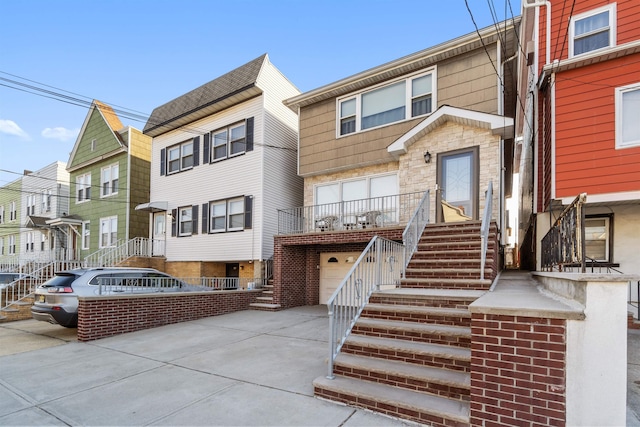 townhome / multi-family property featuring stairway, an attached garage, and concrete driveway