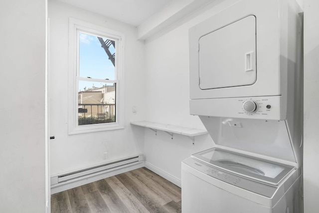 609 New York Ave Unit 2L, Union City, NJ 07087 - laundry room with stacked washer / drying machine, a baseboard radiator, and wood finished floors