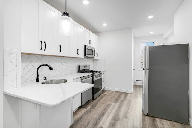 609 New York Ave Unit 2L, Union City, NJ 07087 - kitchen with stainless steel appliances, white cabinetry, light stone counters, tasteful backsplash, and recessed lighting