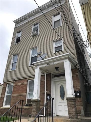 1402 10th St, North Bergen, NJ 07002 - view of front of home featuring brick siding