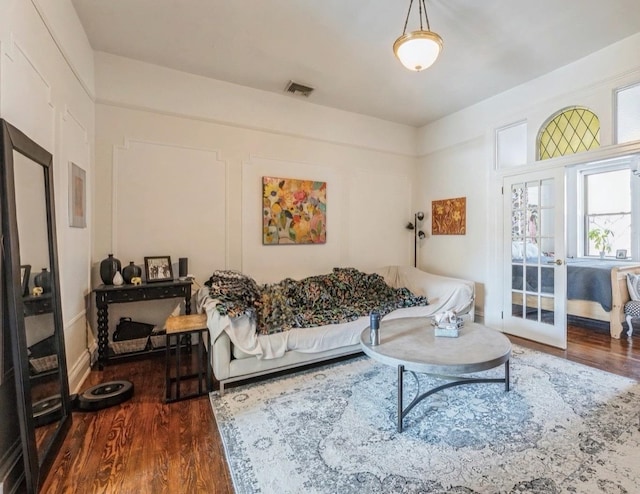 living room featuring dark hardwood / wood-style flooring and french doors