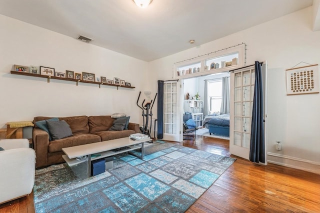 living room with wood-type flooring and french doors