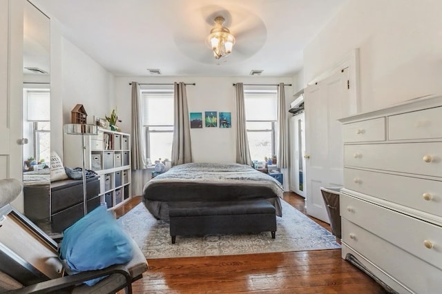 bedroom with ceiling fan and dark wood-type flooring