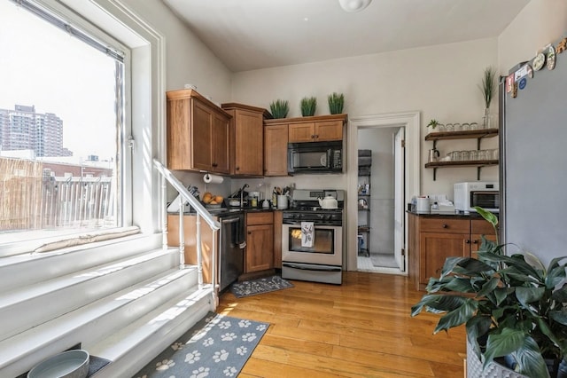 kitchen with gas range and light hardwood / wood-style flooring