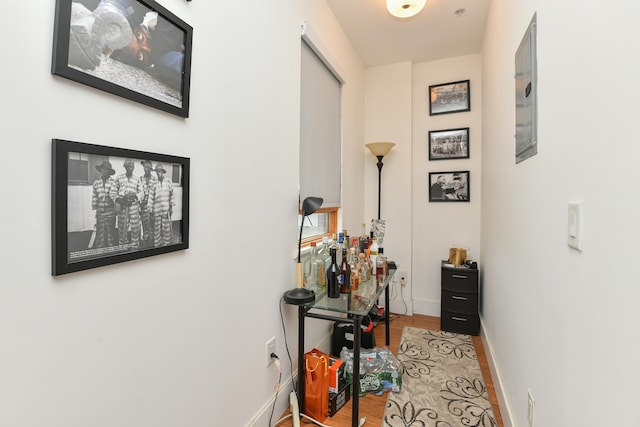 hallway with light wood-style floors and baseboards