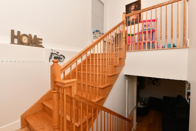 staircase featuring wood finished floors