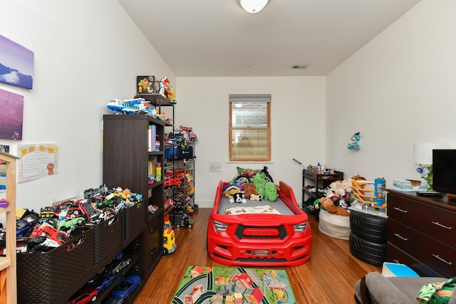 game room with wood finished floors and visible vents