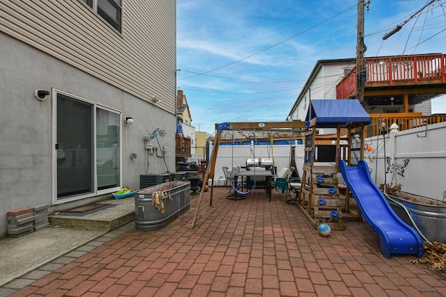 view of patio / terrace featuring a playground and a fenced backyard