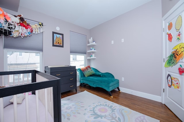 bedroom with baseboards and wood finished floors