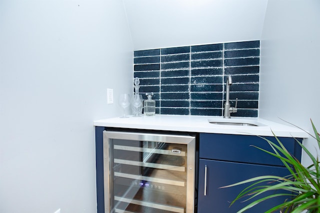 bar with indoor wet bar, a sink, and wine cooler