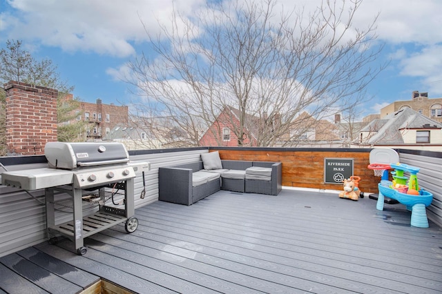 wooden terrace featuring a grill