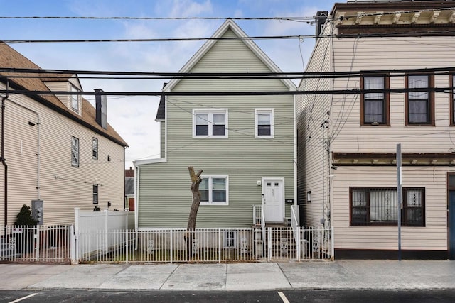 multi unit property with a fenced front yard and a gate