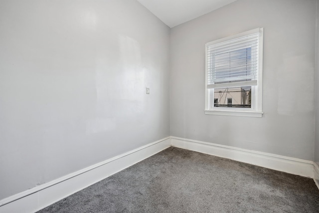 spare room with carpet flooring and baseboards