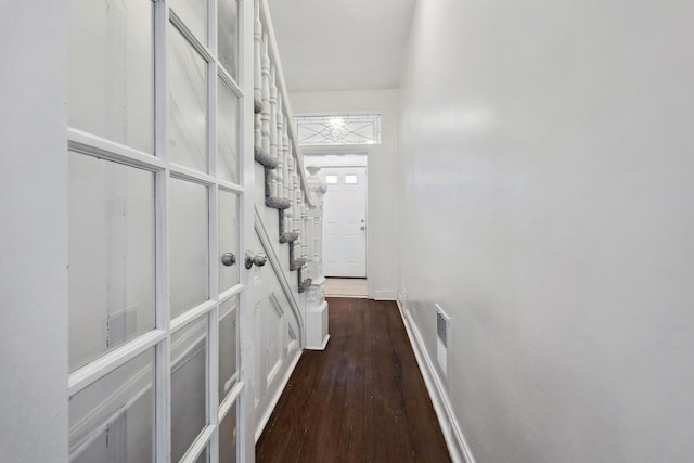 hall with baseboards and dark wood-style flooring